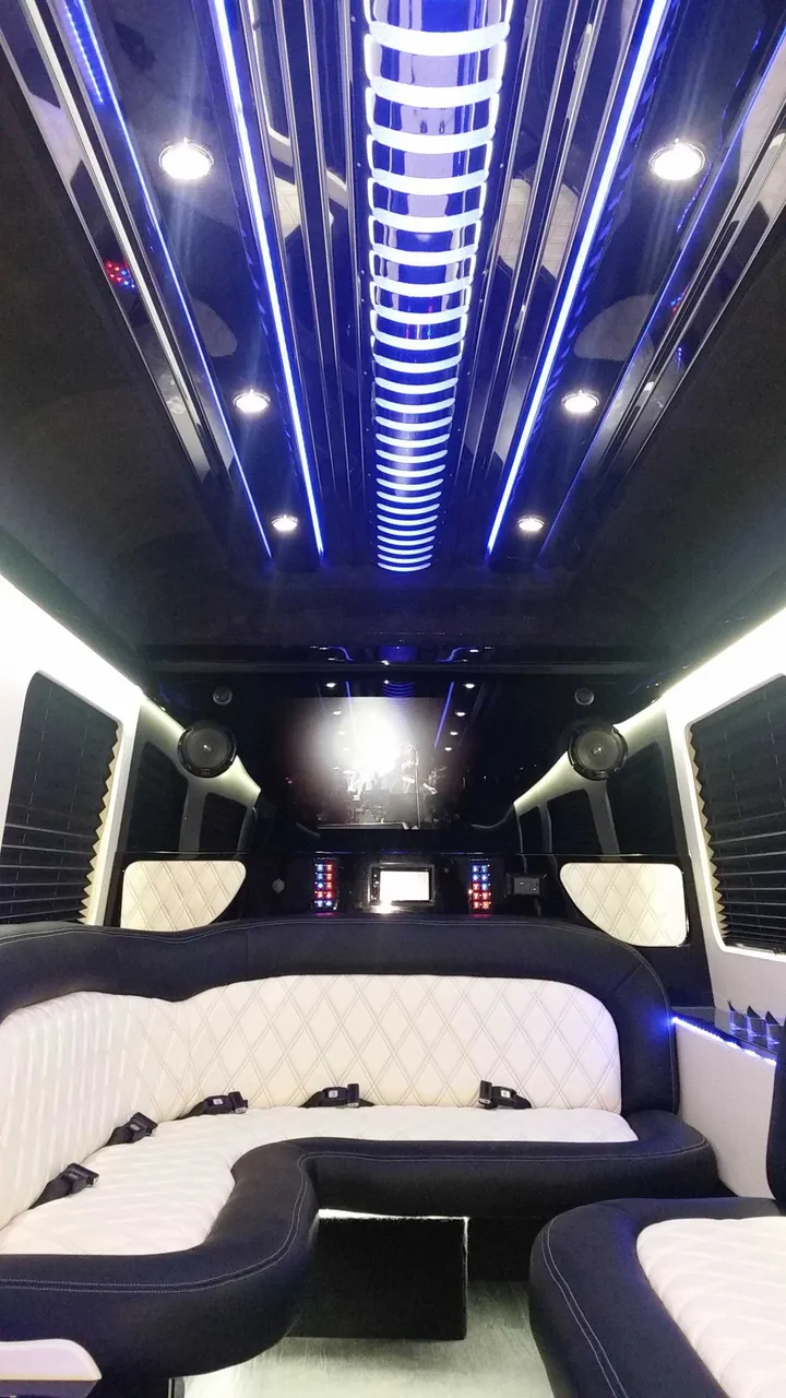 Mercedes Sprinter Limousine interior with perimeter lounge seating, sofa-style seating and window shades, photo 3 for party bus rental