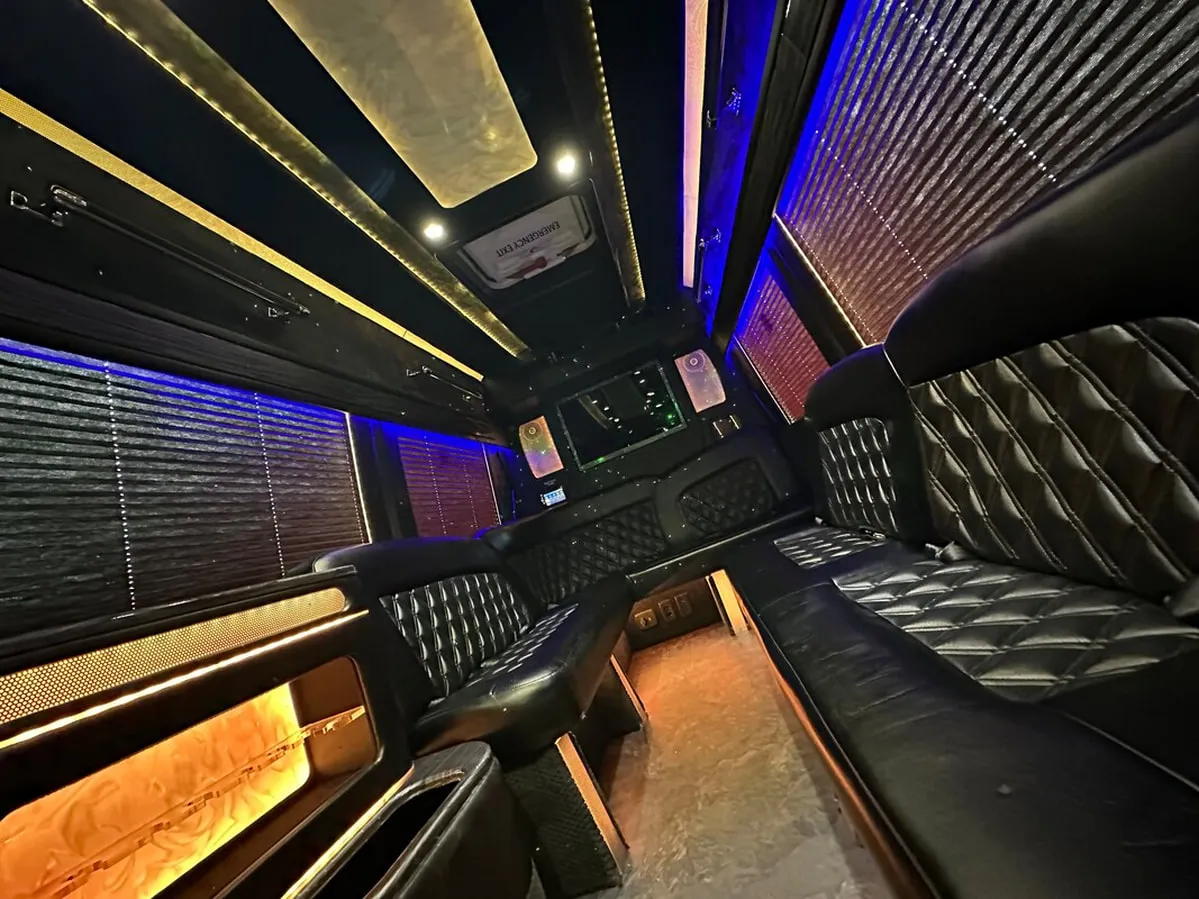 Mercedes-Benz Sprinter XL interior with perimeter lounge seating, window shades and LED accent lighting, photo 2 for party bus rental