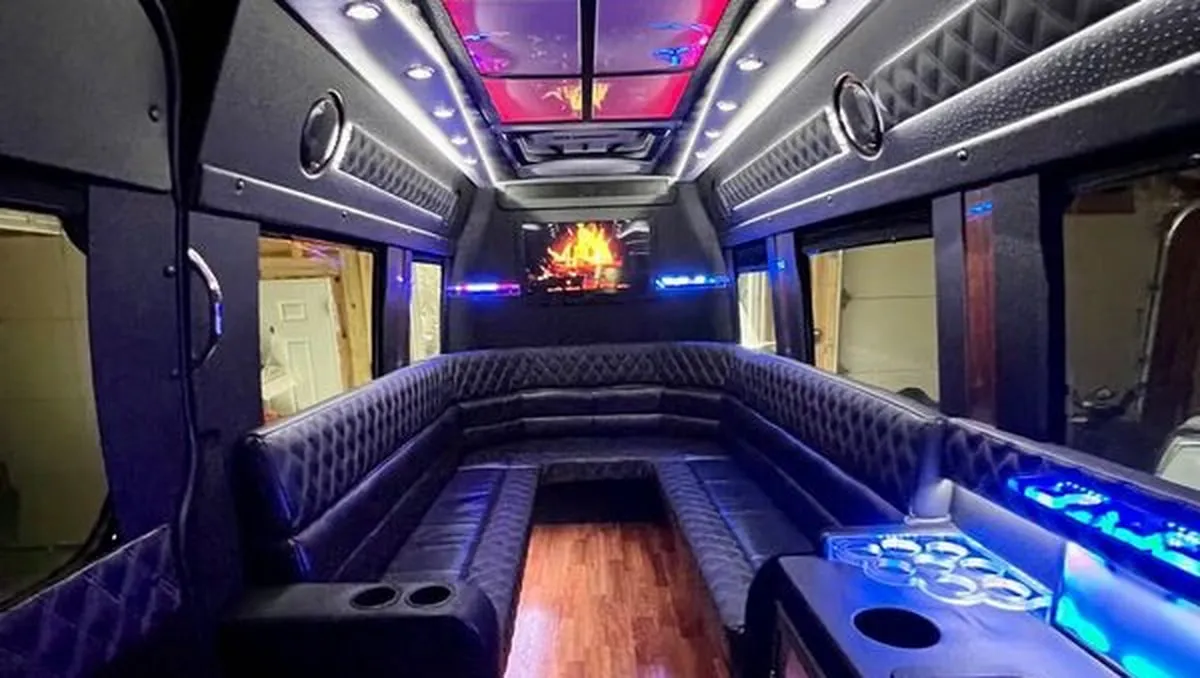 Mercedes-Benz Sprinter XL Mercedes-Benz Sprinter XL interior with perimeter lounge seating, sofa-style seating and cup holders for party bus rental