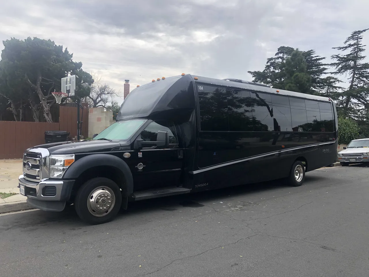 Black 21 Passenger Mini Coach with tinted windows for charter bus rental in San Diego County, CA