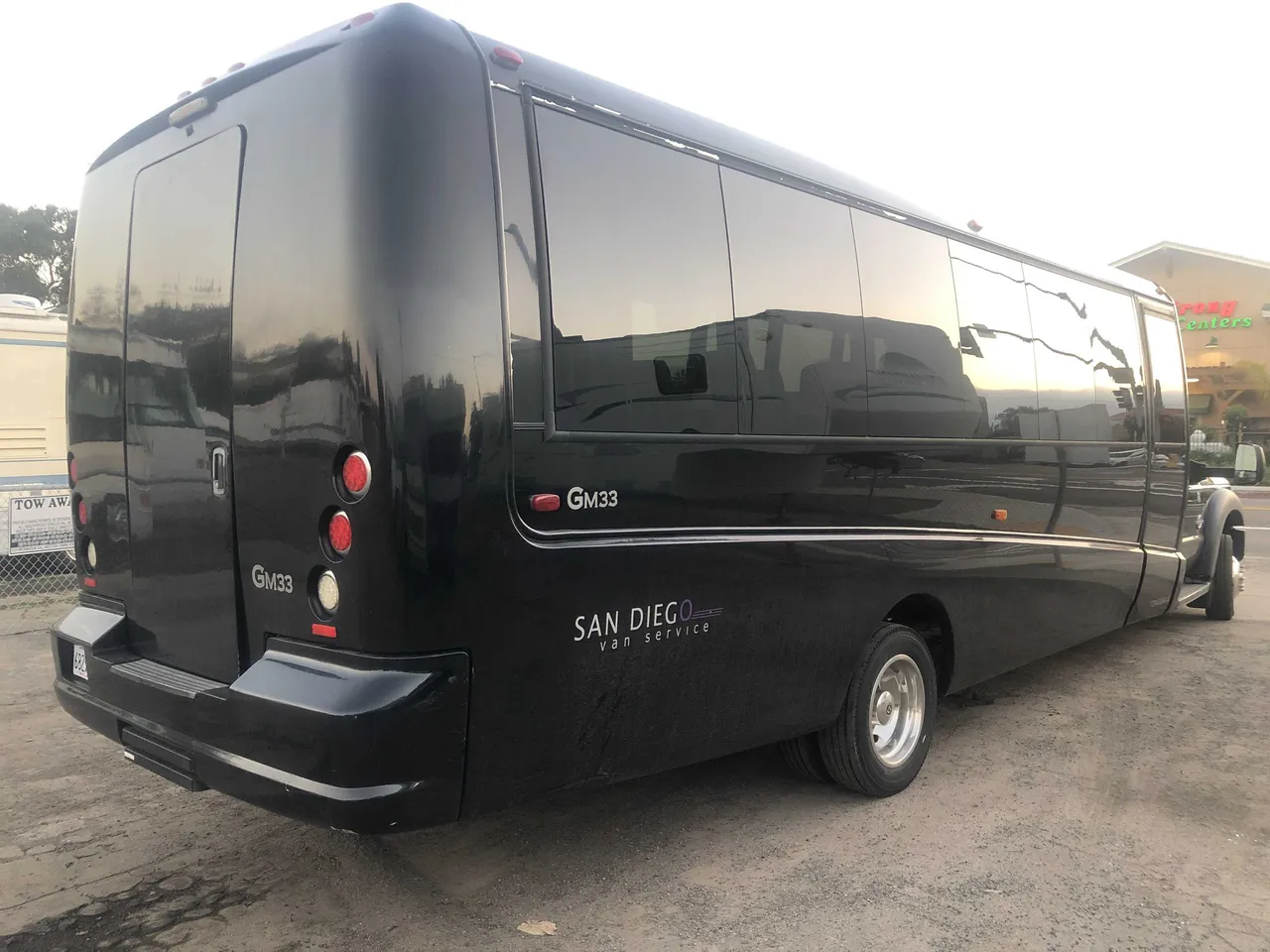 Black 21 Passenger Mini Coach exterior with tinted windows for charter bus rental in San Diego County, CA