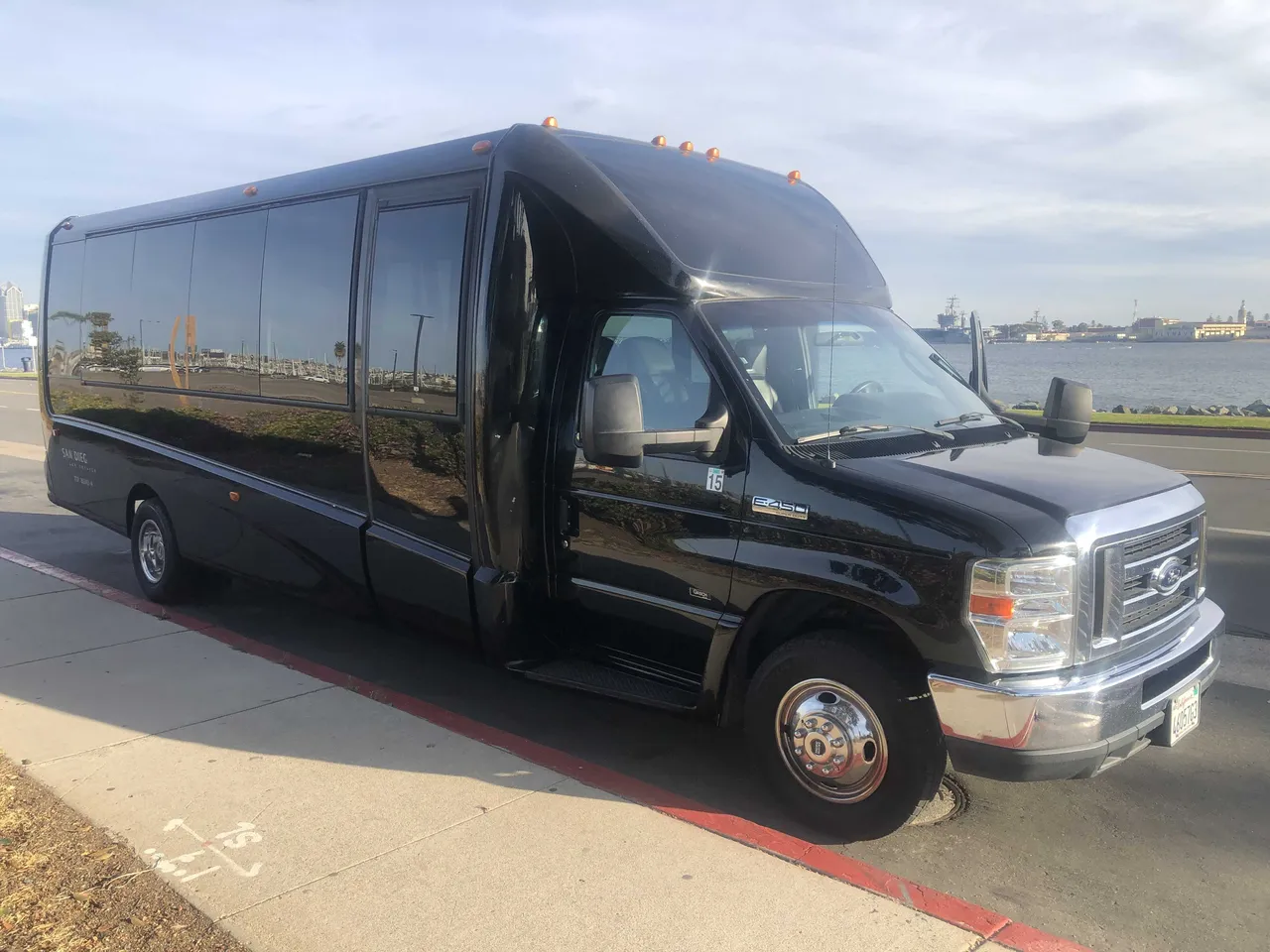 Black 21 Passenger Mini Coach exterior with tinted windows, photo 3 for charter bus rental in San Diego County, CA