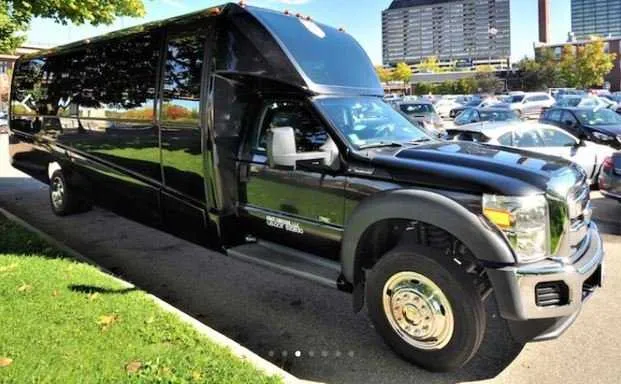 The black Mini Coach Limousine Bus, showing tinted windows
