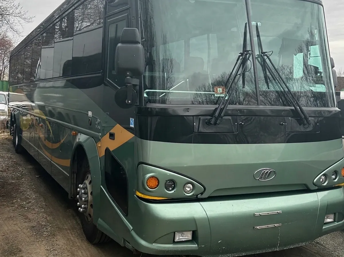 The green 55 Passenger Motor Coach, ready to rent