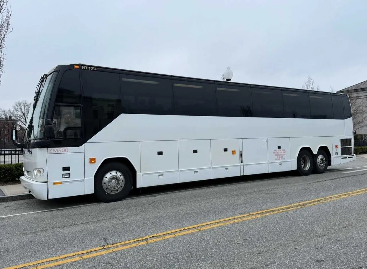 White 55 Passenger Motorcoach with tinted windows for charter bus rental