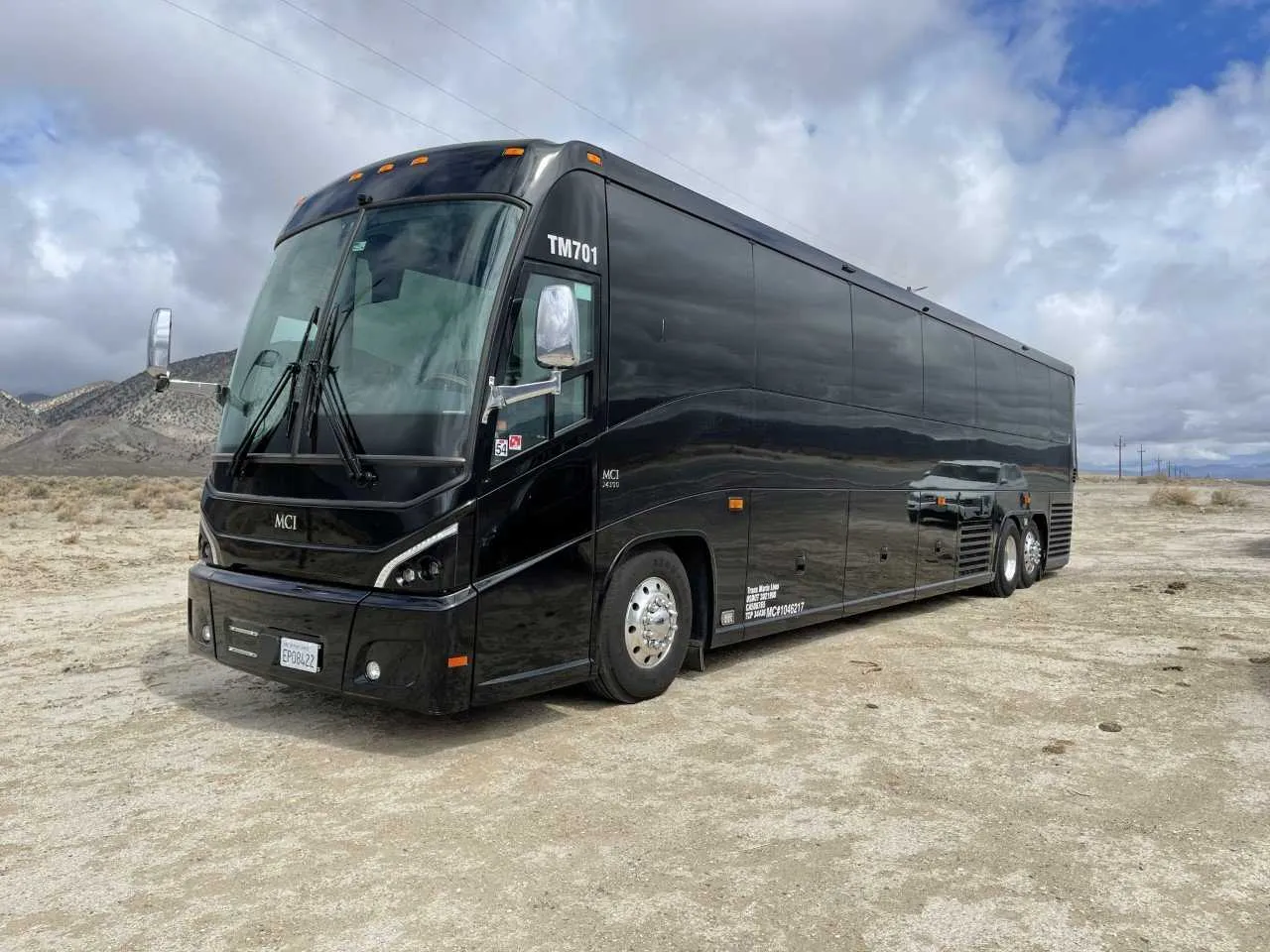 Black 56 Passenger Motorcoach with tinted windows for charter bus rental in Keyes, CA