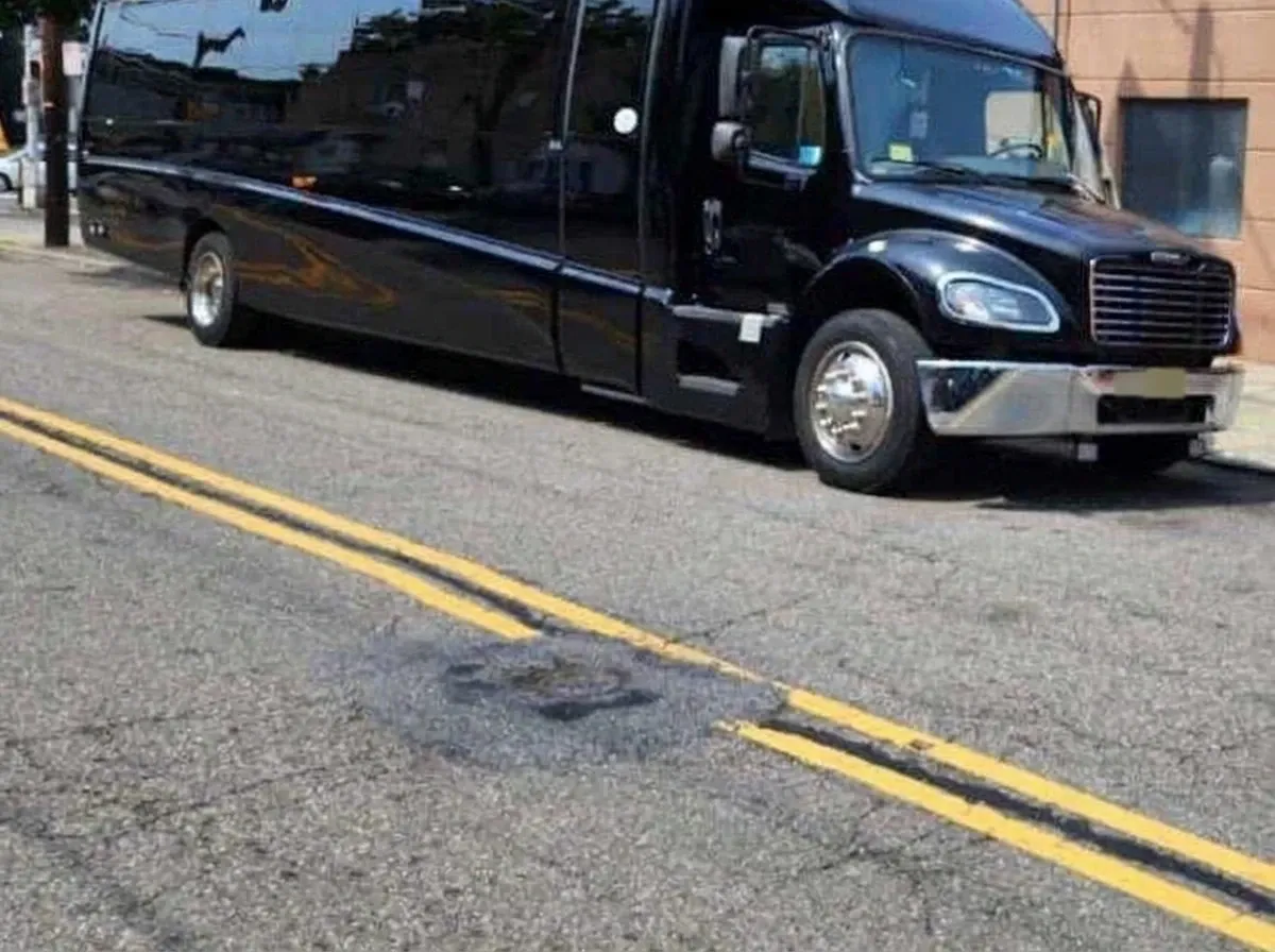 The black 40 Passenger Motorcoach, ready to rent