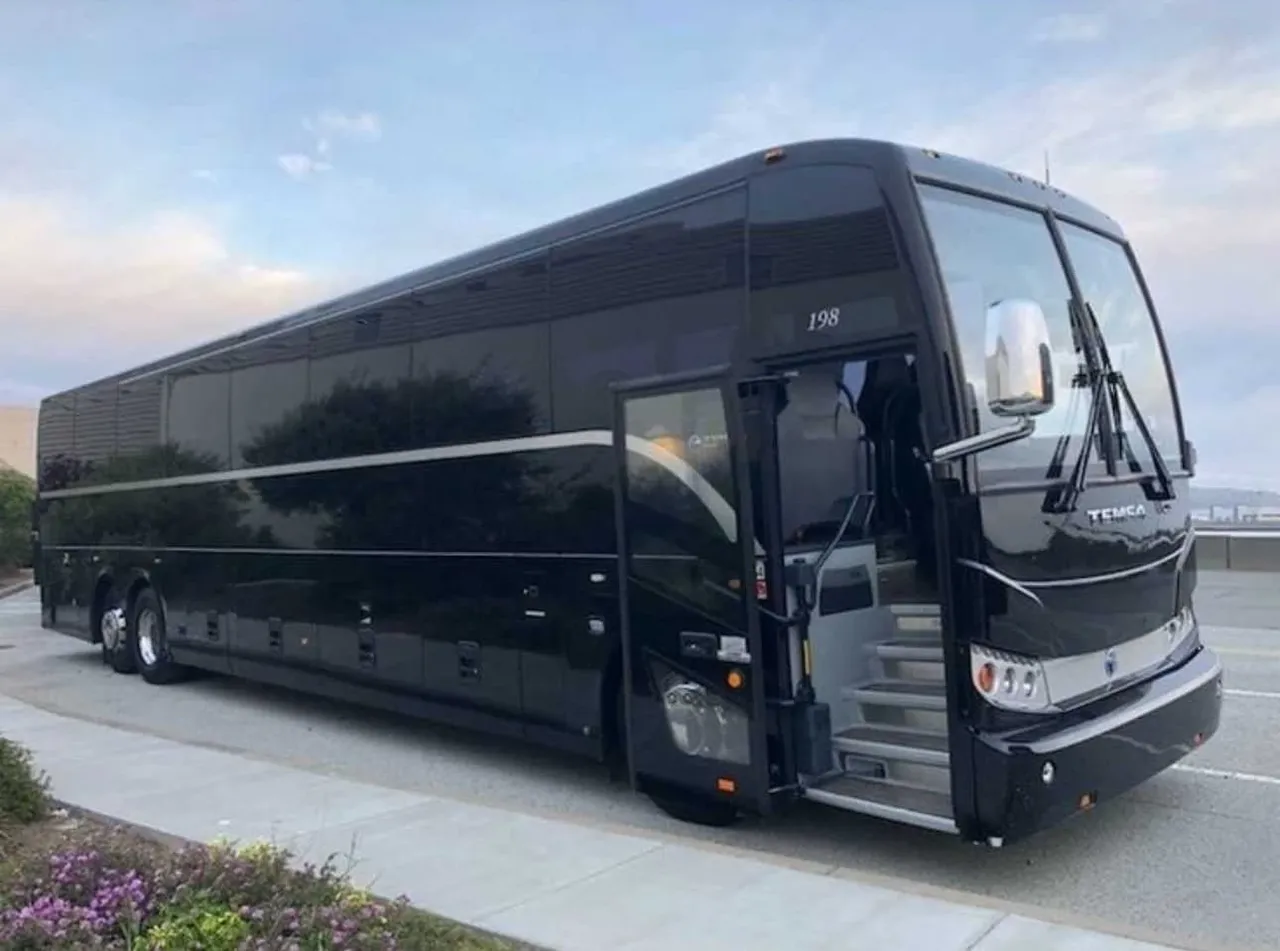 The black 56 Passenger Motorcoach, ready to rent