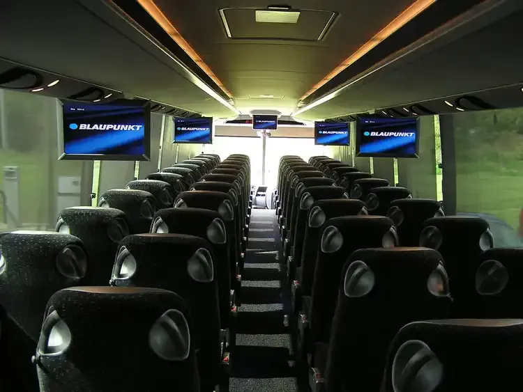 40 Passenger Motorcoach interior with LED ceiling lighting and TV screens for charter bus rental in Saint Paul, MN
