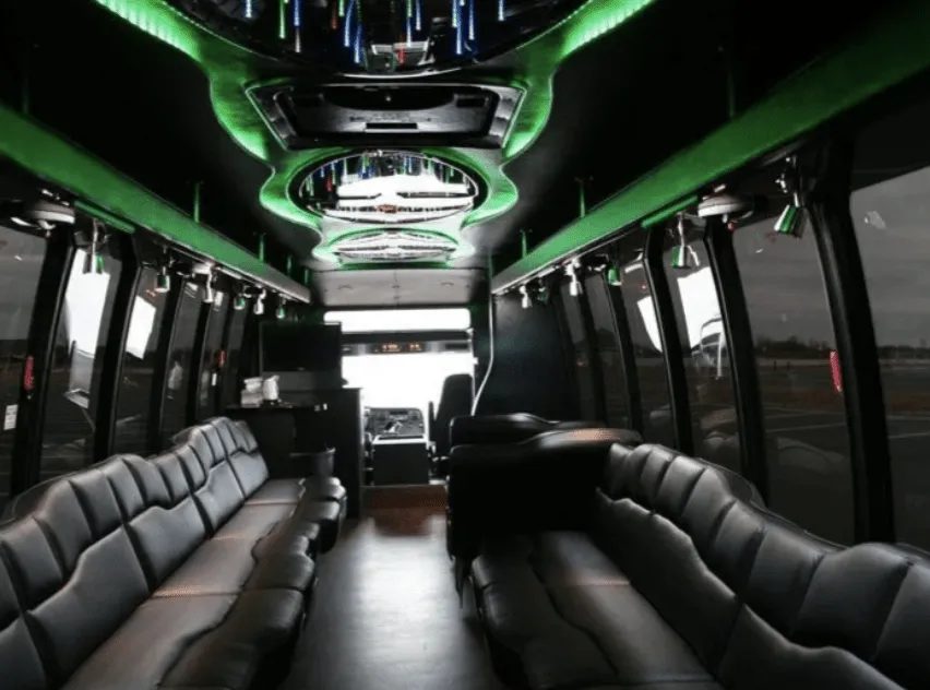 28 Passenger Party Bus interior with perimeter lounge seating, LED accent lighting and LED ceiling lighting for party bus rental in Saint Paul, MN
