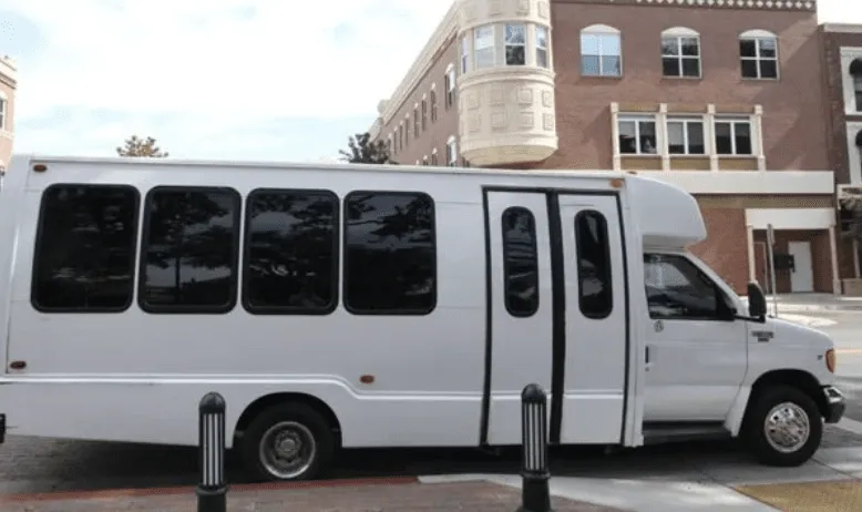 White 16 Passenger Party Bus exterior with tinted windows for party bus rental in Paso Robles, CA