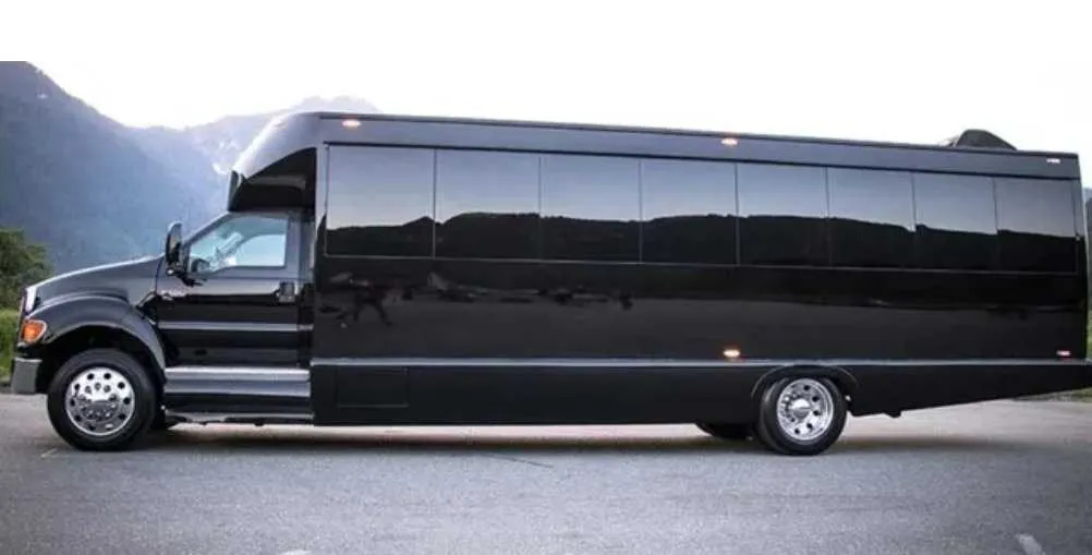 Black 30 Passenger Party Bus exterior with tinted windows for party bus rental in Schertz, TX