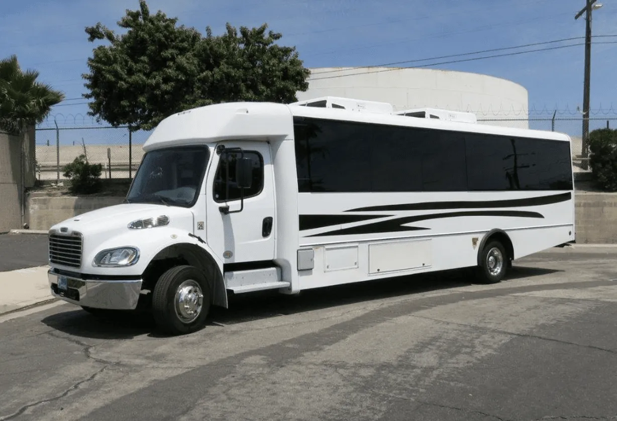 White 26 Passenger Party Bus exterior with tinted windows for party bus rental in Keyes, CA