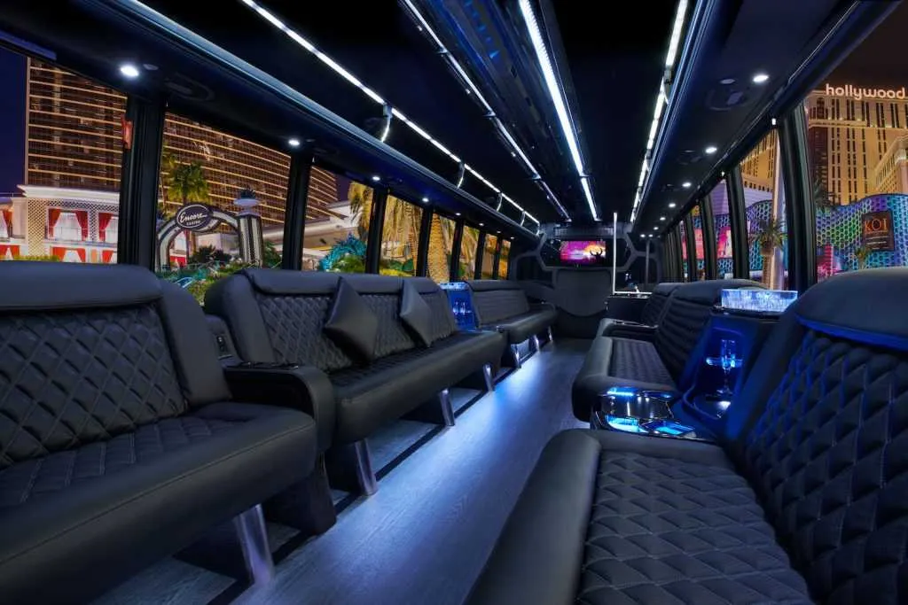 30 Passenger Party Bus interior with perimeter lounge seating, LED accent lighting and LED ceiling lighting for party bus rental in Dallas, TX