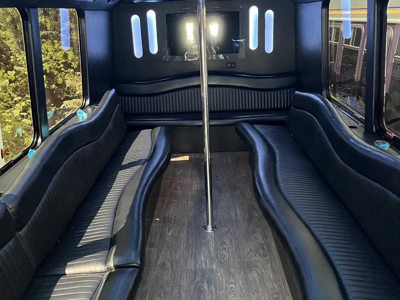 The white 18 Passenger Party Bus, shot 3