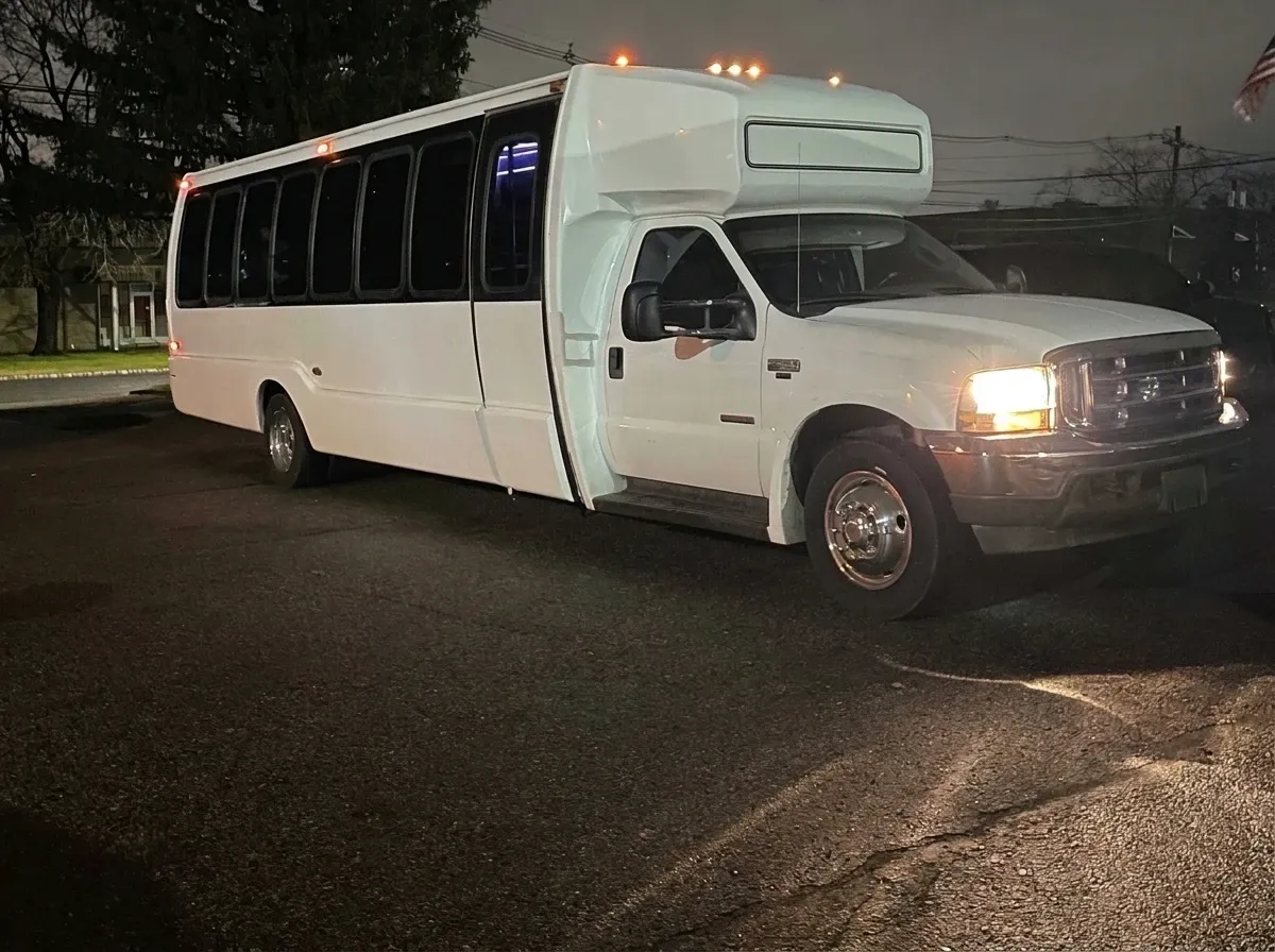 The white 30 Passenger Party Bus, shot 2