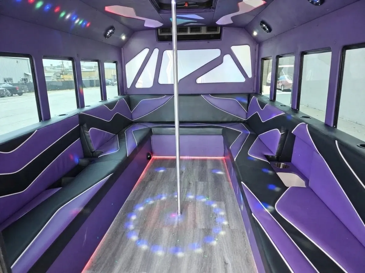 The white Purpleline Party Bus, ready to rent