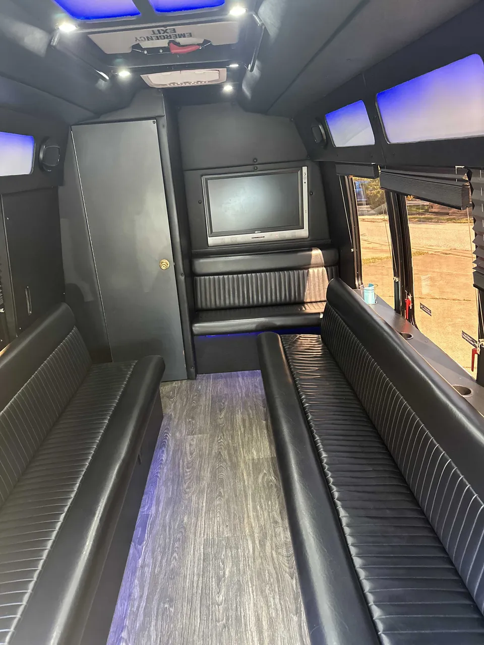 Small Party Bus interior with perimeter lounge seating, LED accent lighting and LED ceiling lighting for party bus rental in Pittsburgh, PA