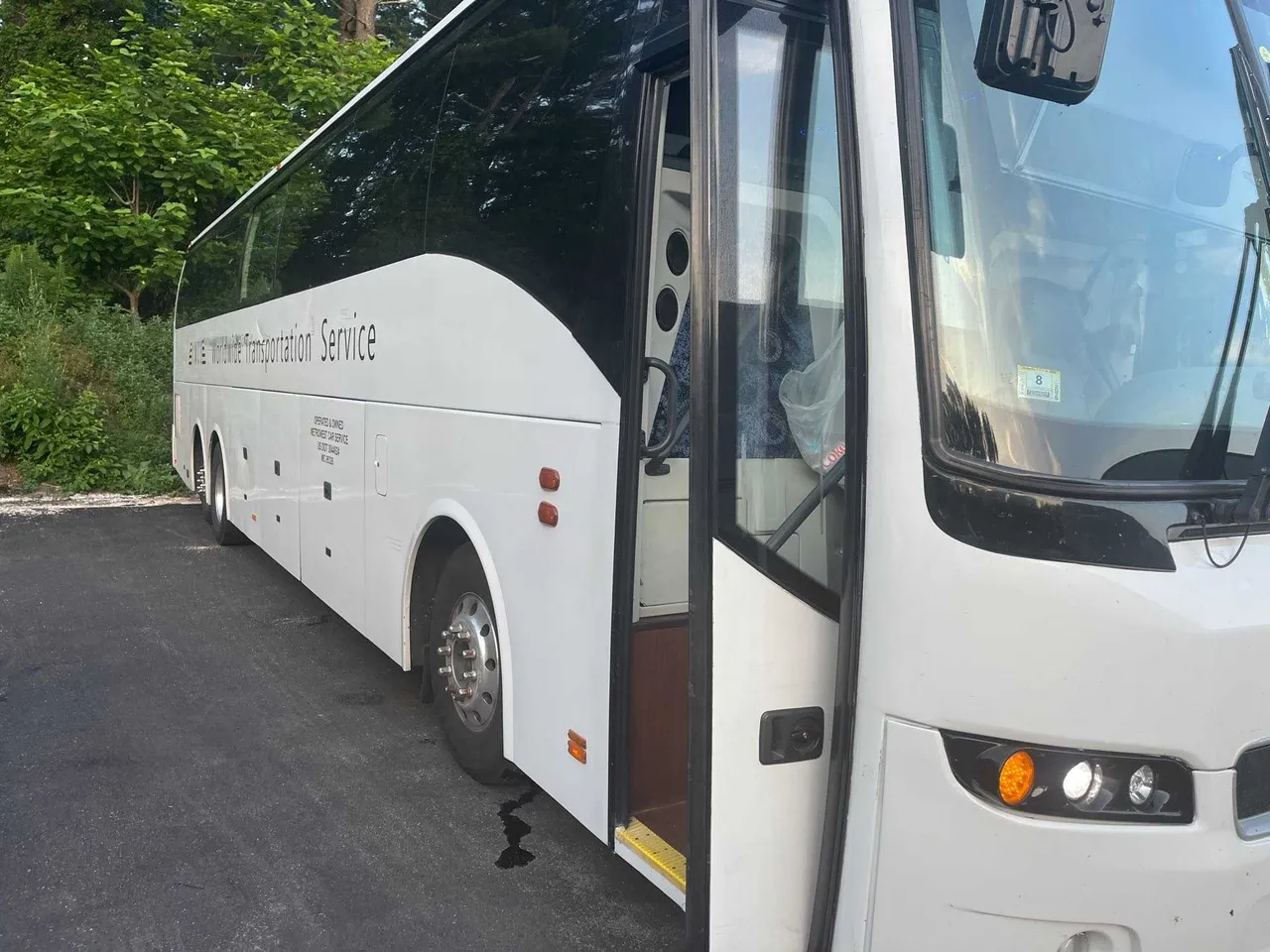White Volvo Motor Coach with tinted windows for charter bus rental