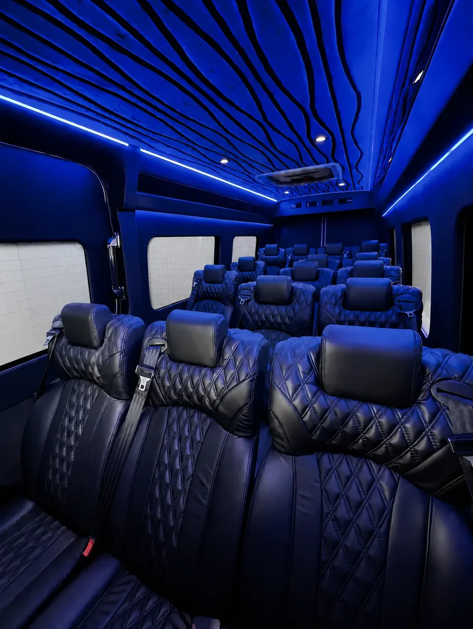 White Luxury Sprinter Shuttle Van interior with window shades, LED accent lighting and LED ceiling lighting for charter bus rental in Walnut, CA