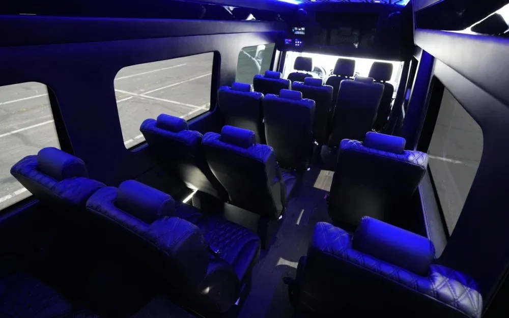 White Luxury Sprinter Shuttle Van interior with LED accent lighting for charter bus rental in Walnut, CA